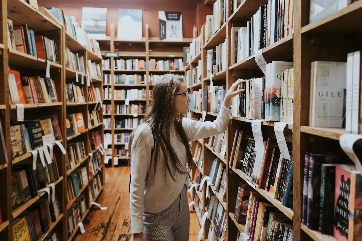 girl looking at books in a bookstore